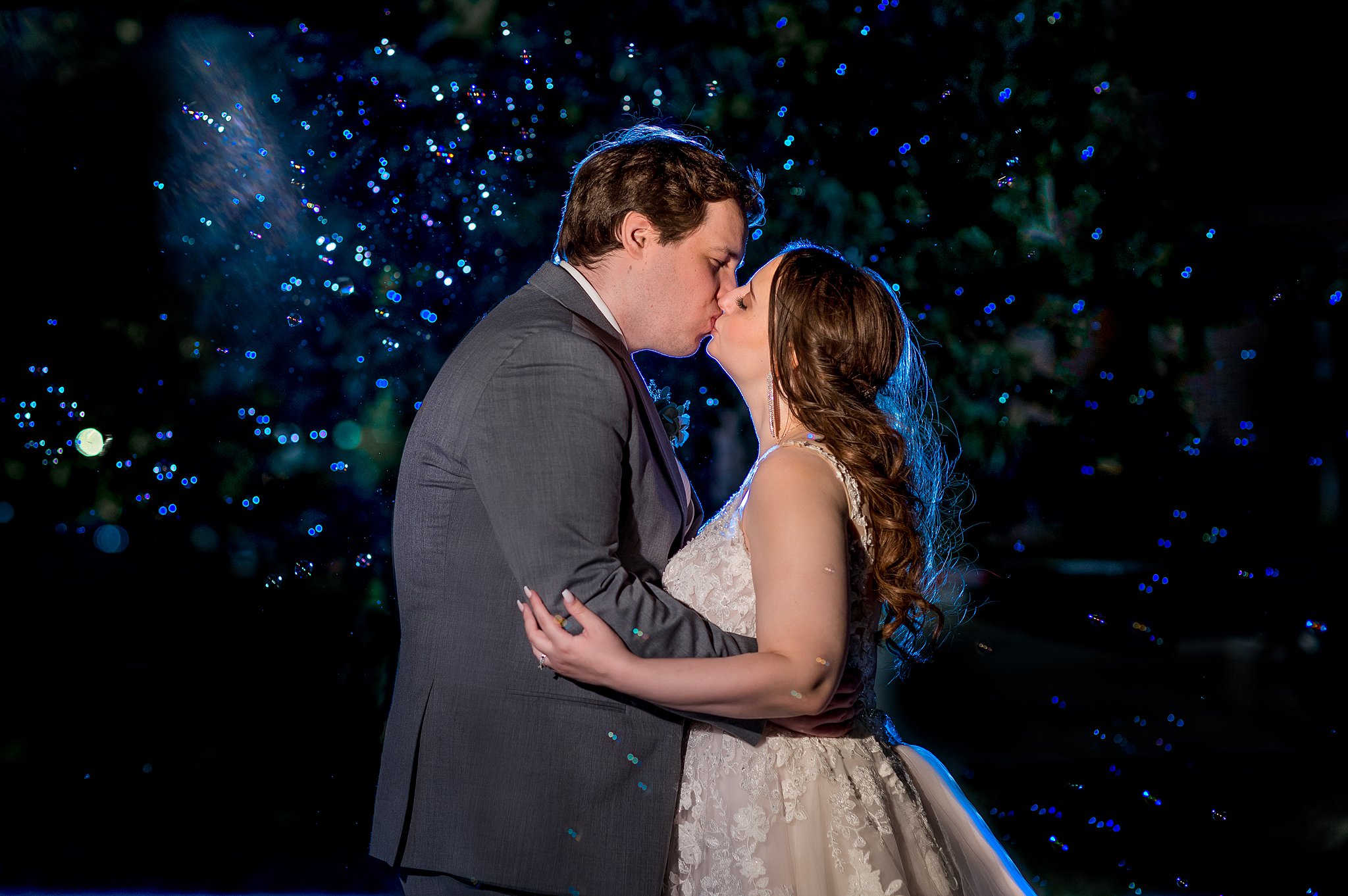 Nighttime wedding portrait in Fargo ND with Bubbles! Image by Abby Anderson 